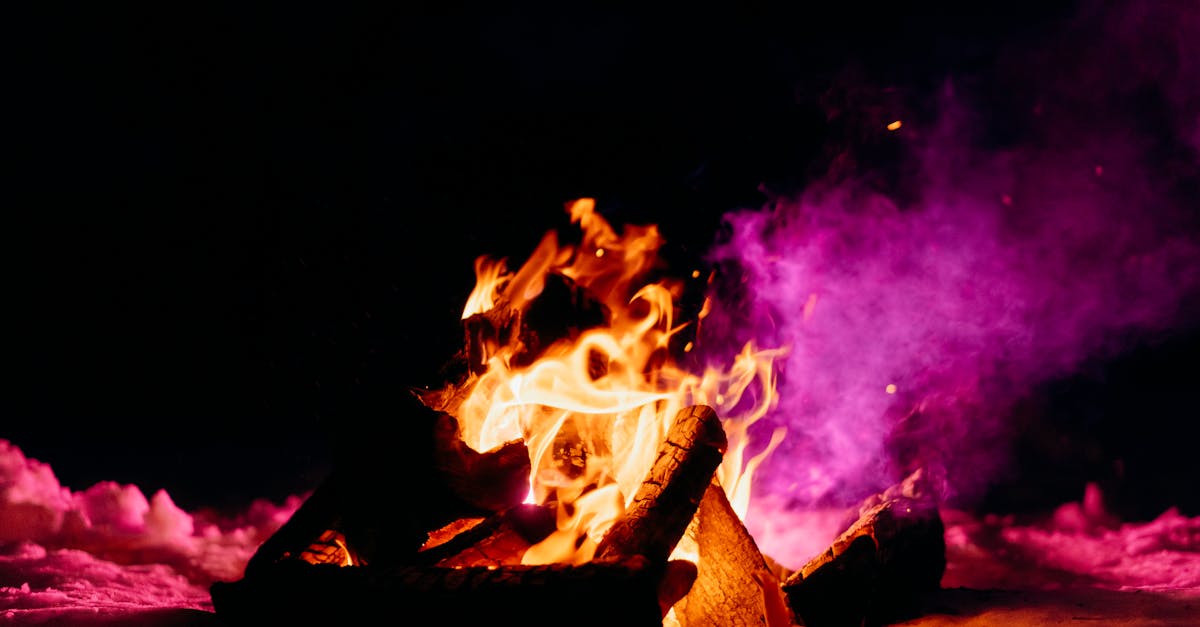 A lively winter bonfire illuminating the snow and creating a warm contrast against the dark night sky.